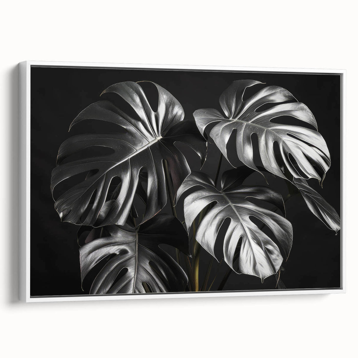Framed canvas wall art showcasing a botanical monstera design with vibrant green leaves against a white background, perfect for modern home decor.