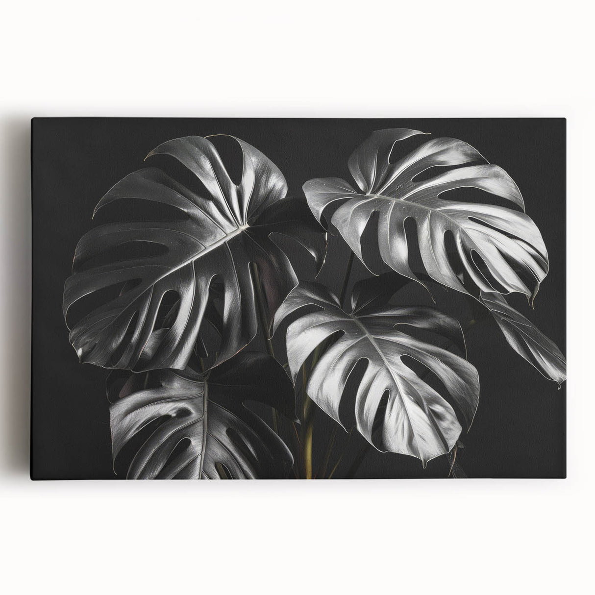 Stretched canvas wall art featuring a vibrant Monstera leaf botanical design, showcasing rich greens and detailed textures, perfect for home decor.