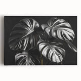 Stretched canvas wall art featuring a vibrant Monstera leaf botanical design, showcasing rich greens and detailed textures, perfect for home decor.