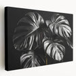 Stretched canvas wall art featuring a vibrant botanical Monstera design, showcasing lush green leaves against a neutral background, ideal for home decor.