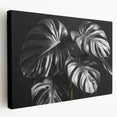 Stretched canvas wall art featuring a vibrant botanical Monstera design, showcasing lush green leaves against a neutral background, ideal for home decor.