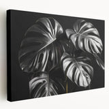 Stretched canvas wall art featuring a vibrant botanical Monstera design, showcasing lush green leaves against a neutral background, ideal for home decor.
