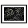 Framed botanical wall art featuring a Monstera plant design set against a black background, highlighting vibrant green leaves in a modern aesthetic. Perfect for home decor.
