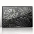 Framed botanical wall art featuring a Monstera plant design in black acrylic, showcasing vibrant green hues and intricate leaf details, perfect for home decor.