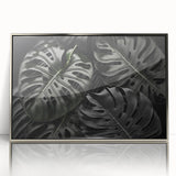 Framed wall art featuring a botanical Monstera design in vibrant green hues, accented with a sleek silver frame, perfect for modern home decor.
