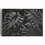 Stretched canvas print showcasing a vibrant botanical monstera design with lush green foliage, perfect for enhancing home decor and adding a tropical touch.