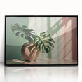 Framed wall art featuring a botanical Monstera design, showcasing vibrant green leaves against a black background, ideal for modern home decor.