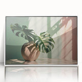 Framed wall art featuring a botanical monstera design in vibrant green hues, displayed in an elegant white frame, perfect for enhancing home decor with a touch of nature.