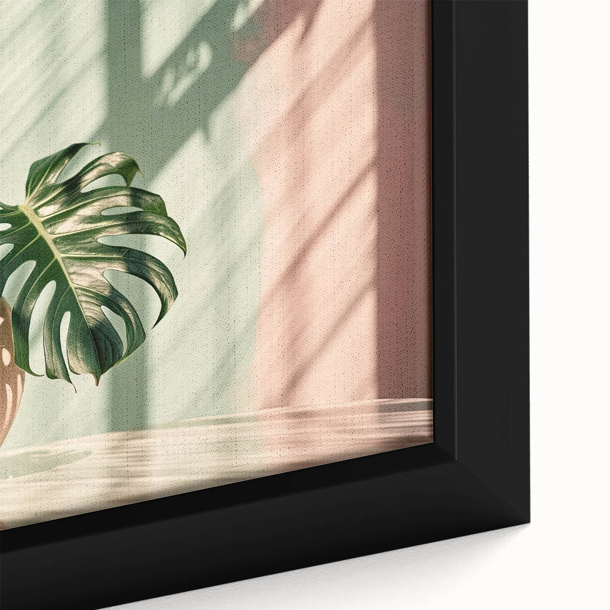 Close-up of a framed botanical Monstera wall art design showcasing vibrant green leaves against a neutral background, perfect for home decor enthusiasts. Ideal for adding a touch of nature to modern interiors.