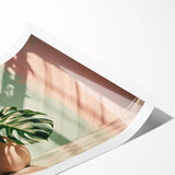 Rolled print showcasing a botanical monstera design with vibrant green leaves, perfect for home decor or wall art collection, packaged securely for delivery.