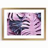 Botanical monstera wall art print in a gold frame with matting, showcasing vibrant green foliage against a neutral background, perfect for home decor enthusiasts.