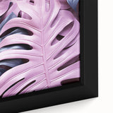 Close-up of a framed botanical art print featuring a vibrant monstera leaf design on textured canvas, ideal for home decor and nature-inspired interiors.