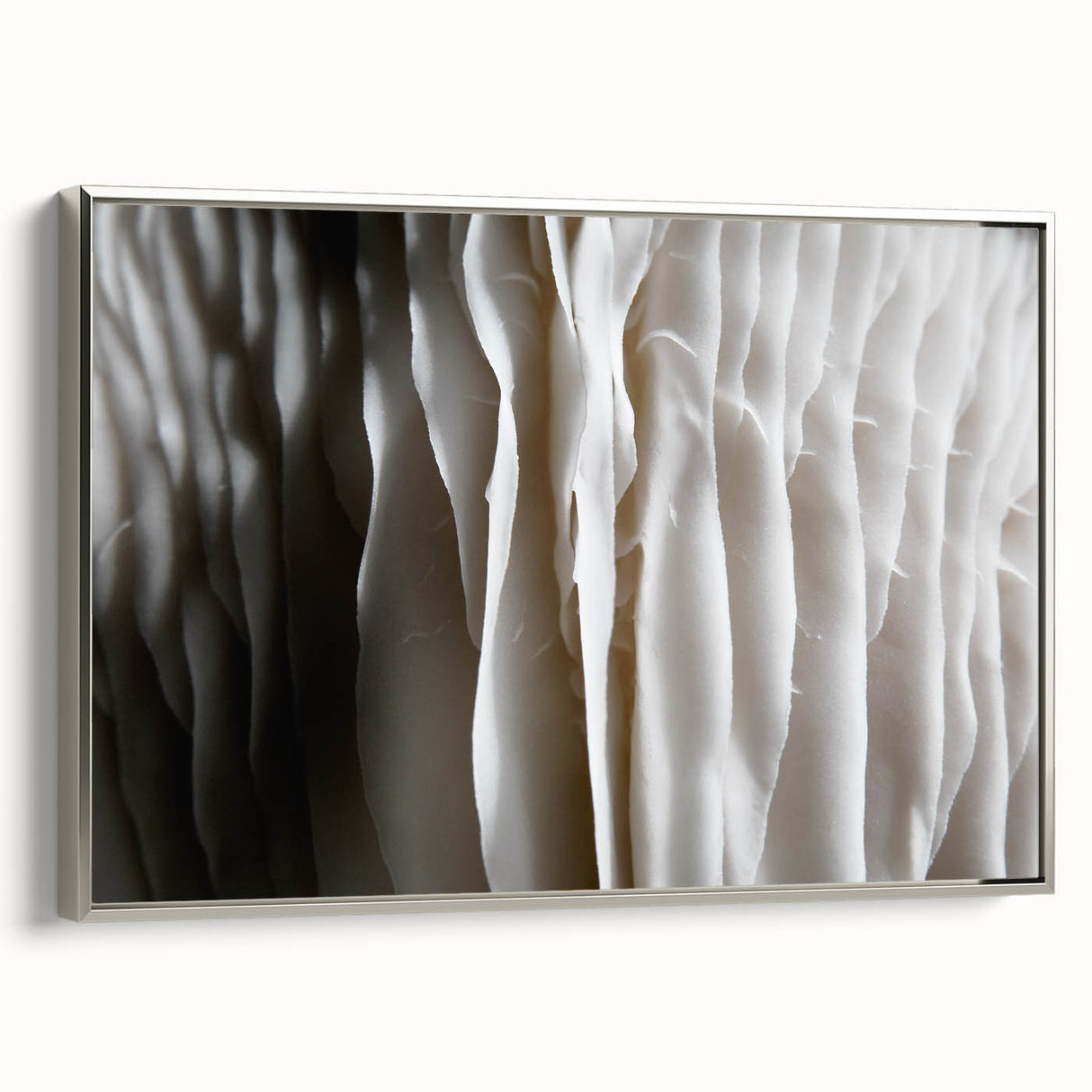 Framed wall art featuring a botanical design of mushrooms and flowers, elegantly displayed with a silver frame, perfect for home decor enthusiasts.