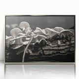 Framed wall art featuring a botanical design of colorful flowers and mushrooms, displayed in a sleek silver frame, perfect for enhancing home decor.