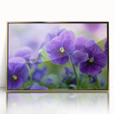 Framed botanical wall art featuring a vibrant pansy design with gold accents, displayed in an elegant acrylic frame, ideal for adding a touch of nature to home decor.