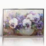 Framed wall art showcasing a botanical design of vibrant pansies in a silver-acrylic frame, perfect for adding a touch of nature-inspired elegance to home decor.