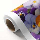 Rolled canvas print showcasing a vibrant botanical design featuring colorful pansies against a soft background, perfect for home decor or art collection.
