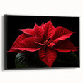 Framed canvas wall art featuring a botanical poinsettia design, showcasing vibrant red and green colors with a sleek black frame, ideal for home decor enhancement.
