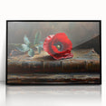 Framed wall art featuring a botanical poppy design with vibrant red and green colors, elegantly displayed in a sleek black frame, ideal for home decor.