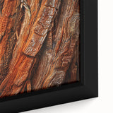 Close-up of a framed botanical wall art piece showcasing vibrant flowers against a backdrop of majestic redwood trees, perfect for nature-inspired decor.