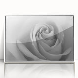 Framed botanical wall art featuring a delicate rose design, displayed in a sleek white frame, perfect for adding elegance to any room decor.