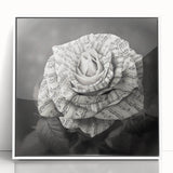 Framed wall art featuring a botanical rose design in vibrant pink and green hues, elegantly displayed with a white frame, adding a touch of nature-inspired decor to any space. Perfect for enhancing home aesthetics, this piece complements various interior styles.