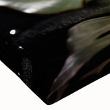 Close-up of a stretched canvas featuring a botanical rose design with vibrant pink and green hues, showcasing intricate floral details ideal for home decor.