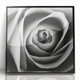 Framed wall art featuring a botanical rose design with vibrant pink and green colors, enclosed in a sleek black frame, perfect for home or office decor.