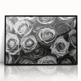 Framed wall art featuring a botanical rose design in vibrant colors, set in a sleek black frame, ideal for home decor or floral-themed interiors.