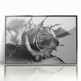 Framed wall art showcasing a botanical rose design, featuring vibrant pink and green hues in a sleek silver frame, ideal for home decor enhancement.