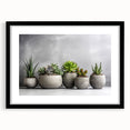 Framed botanical wall art featuring a collection of colorful succulents, showcased with a sleek black frame and white mat, ideal for home decor and nature enthusiasts.