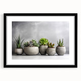 Framed botanical wall art featuring a collection of colorful succulents, showcased with a sleek black frame and white mat, ideal for home decor and nature enthusiasts.