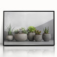 Framed wall art featuring a vibrant botanical design of succulents in a black frame, showcasing intricate details and vibrant colors, perfect for home decor.
