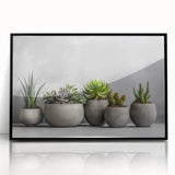 Framed wall art featuring a vibrant botanical design of succulents in a black frame, showcasing intricate details and vibrant colors, perfect for home decor.
