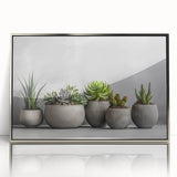 Framed wall art featuring a botanical design of colorful succulents in a silver-acrylic frame, perfect for modern home decor accents and nature enthusiasts.
