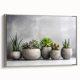 Framed wall art featuring a botanical design of colorful succulents presented in a sleek silver frame, ideal for modern home decor and plant enthusiasts.