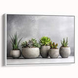 Framed canvas wall art showcasing a botanical design of colorful succulents, set against a white background, highlighting the intricate details and textures of the plants.