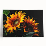 Stretched canvas wall art featuring a vibrant botanical sunflower design, leaning against a white wall, showcasing bright yellow petals and intricate details. Perfect for adding a cheerful touch to any room decor.