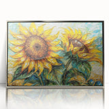 Framed wall art featuring a botanical sunflower design in vibrant yellow and green hues, presented in a sleek silver frame, perfect for home decor.