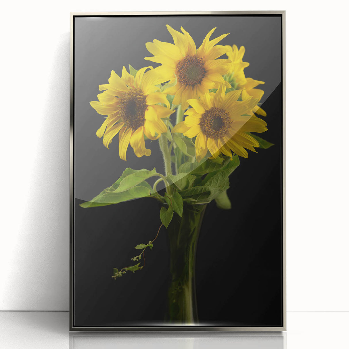 Framed wall art featuring a vibrant botanical sunflower design in shades of yellow and green, set in a sleek silver frame, perfect for enhancing home decor.