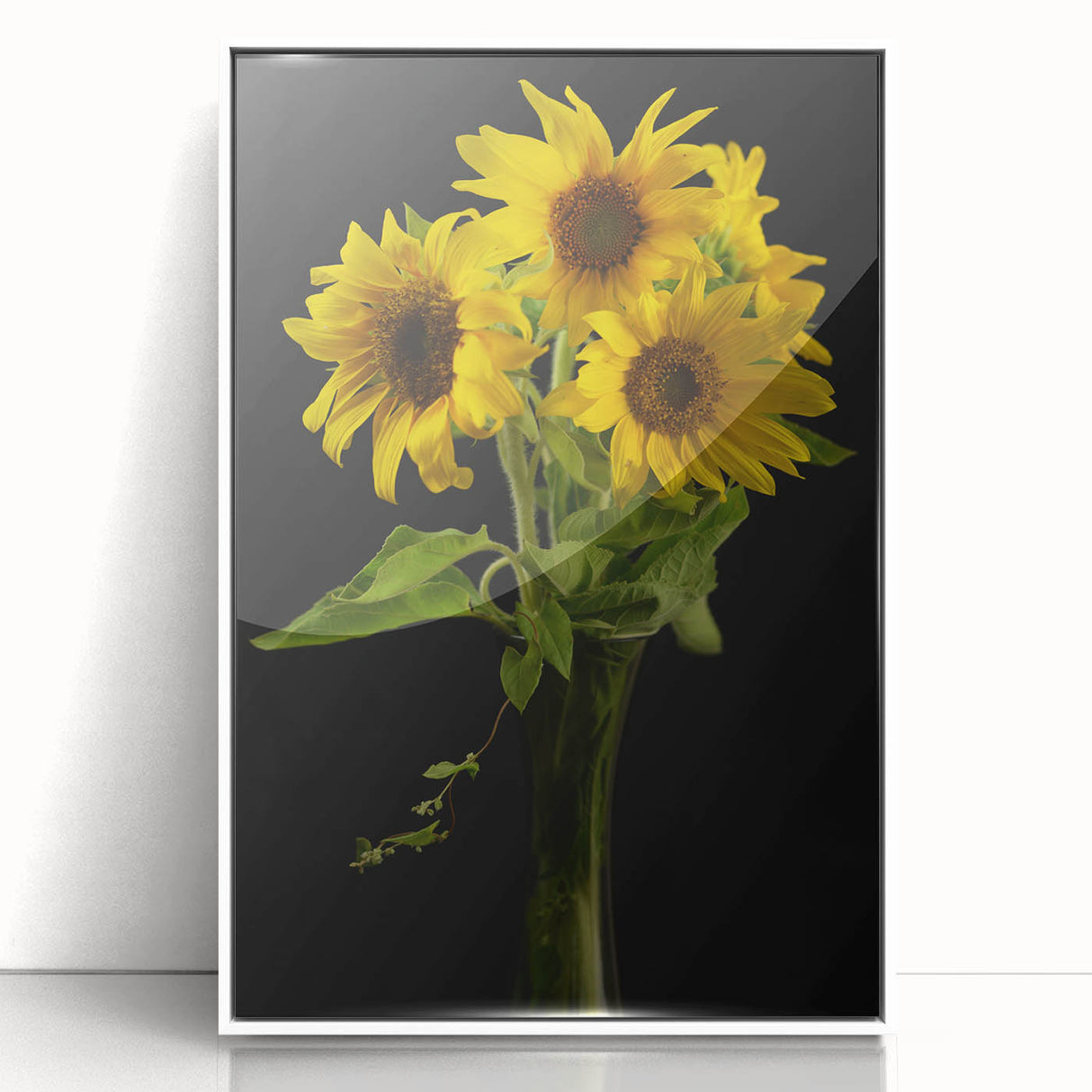 Framed wall art showcasing a botanical sunflower design with vibrant yellow petals, set in a sleek white frame, ideal for home decor and floral enthusiasts.