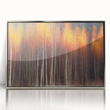 Framed acrylic wall art featuring a botanical design of colorful flowers and trees, elegantly displayed with a silver frame, ideal for home decor.