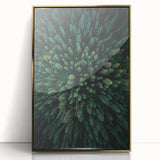 Framed acrylic wall art featuring a botanical design of colorful flowers and trees, elegantly displayed with a gold frame, perfect for home decor.