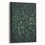 Framed canvas wall art featuring a botanical design of flowers and trees, showcasing intricate details and vibrant colors against a sleek black frame, perfect for home decor.