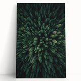 Stretched canvas wall art showcasing a vibrant botanical design featuring colorful flowers and trees, elegantly leaning against a wall in a modern decor setting.