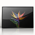 Framed wall art showcasing a vibrant tropical flower design with botanical elements, set in a sleek black frame, perfect for enhancing modern decor.