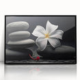 Framed botanical wall art featuring vibrant tropical flowers in a modern black frame. Ideal for home decor, adding a touch of nature and color to any room.