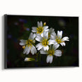 Framed canvas artwork showcasing a vibrant tropical flower design with intricate botanical details, featuring a sleek black frame and displayed in a modern setting.