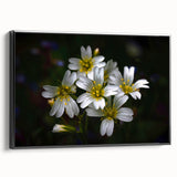 Framed canvas artwork showcasing a vibrant tropical flower design with intricate botanical details, featuring a sleek black frame and displayed in a modern setting.