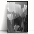 Framed wall art featuring a botanical tulip design in vibrant colors, displayed in a sleek black frame, perfect for adding elegance to home decor.